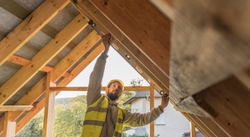 Artisan en train d'installer une surélévation d'une maison en bois à la réunion